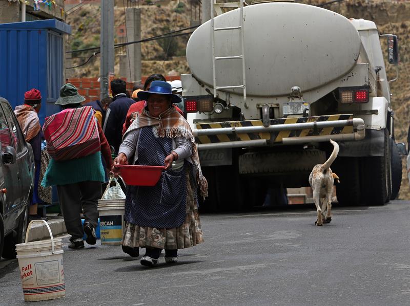 Ciudadanos se abastecen de agua de un gran camión cisterna que distribuye el liquido a los vecinos de las zonas paceñas afectadas por los cortes de agua. 