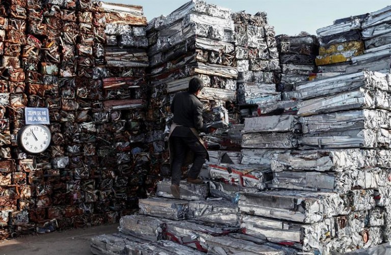 Un hombre trabaja en un centro de recolección de chatarra en el distrito de Shijingshan en Pekín (China)